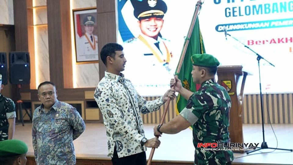 Wakil Bupati Bandung Ali Syakieb menyerahkan bendera secara simbolis kepada instruktur Pusdikbekang AD saat pembukaan Orientasi PPPK Gelombang I Tahun 2026 di Gedung Mohammad Toha, Soreang.